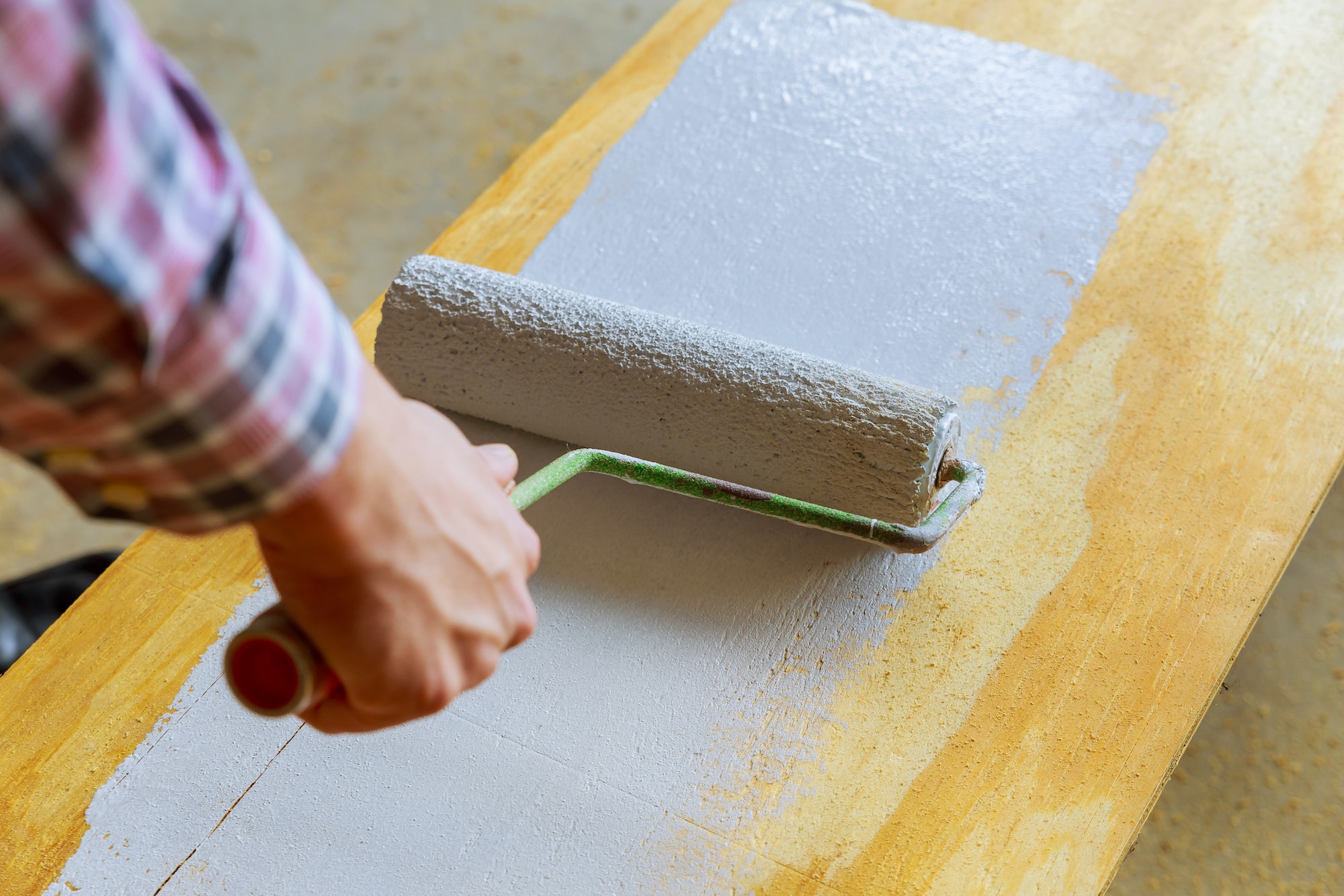 painting the wood with white paint roller House painting,paint roller